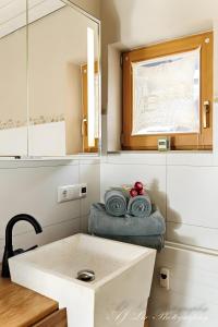 a bathroom with a sink and towels on a counter at Ferienwohnung Bienennest in Mittenwald +18 photos