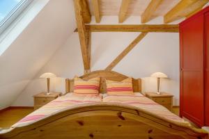 a bedroom with a wooden bed with two lamps at Hof Sinnenberg in Deggenhausertal