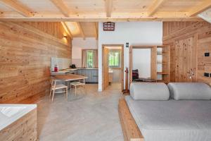 a living room with a bed and a kitchen at Noah Suites in Vigo di Fassa