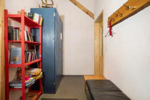 a room with a book shelf with books at Hof Sinnenberg in Deggenhausertal
