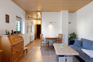 a living room with a couch and a table at Ferienhaus Schmalzgrube in Jöhstadt