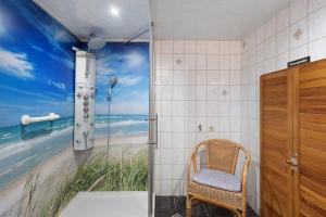 a bathroom with a shower with a view of the beach at Ferienhaus Schmalzgrube in Jöhstadt +20 photos