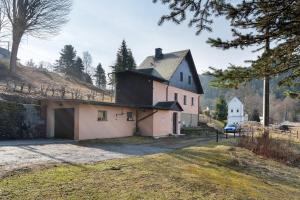 a large white house with a black roof at Ferienhaus Schmalzgrube in Jöhstadt