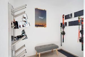 a room with ski equipment on a wall at Stackler54 - mit Balkon in Neustift im Stubaital