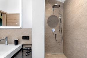 a shower stall in a bathroom with a sink at Stackler54 - mit Balkon in Neustift im Stubaital +22 photos