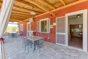 an outdoor patio with a table and chairs at Le Colonie - Pescoluse in Presicce