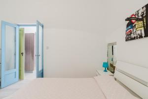 a bedroom with a bed and an open door at Disiu Case Vacanza - Balestrate in Balestrate