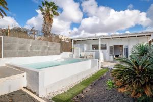 a pool in the backyard of a house at Suite Amanecer in Mácher