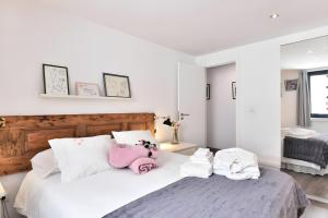 a bedroom with a white bed with a stuffed animal on it at Casa Douro Janja in Armamar +16 photos