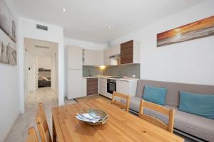 a living room with a couch and a wooden table at Bilocale Mezzano in centro in Varazze