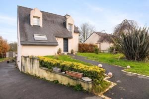 a house with yellow flowers in the driveway at Les chambres de Florence in Saint-Jouan-de-lʼIsle