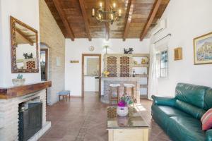 a living room with a couch and a fireplace at Casa Altamar in Barbate