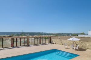 a swimming pool on the balcony of a house at Casa Altamar in Barbate