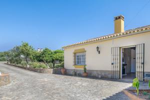 a white house with a door and a driveway at Casa Altamar in Barbate