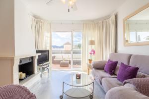a living room with a couch and a table at Casa Chloe in Nerja