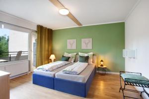 a bedroom with a bed and a green wall at Fewo Kleine Auszeit in Brilon