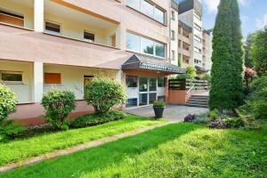 an apartment building with a garden in front of it at Fewo Kleine Auszeit in Brilon