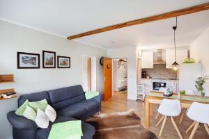 a living room with a couch and a dog laying on the floor at Fewo Kleine Auszeit in Brilon +17 photos