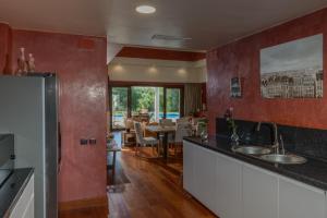a kitchen with two sinks and a dining room at Villa Lara in Benalup Casas Viejas