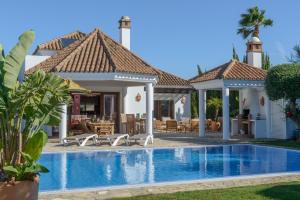 a villa with a swimming pool and a patio at Villa Lara in Benalup Casas Viejas