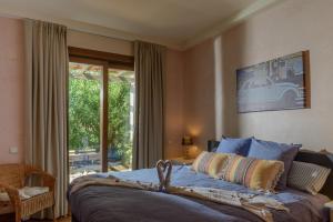 a bedroom with a bed and a large window at Villa Lara in Benalup Casas Viejas +32 photos