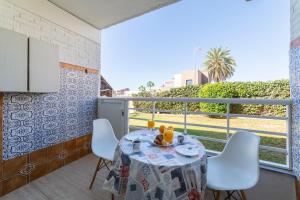 a dining room with a table and chairs and a balcony at Gaviotas 4 in Aguadulce