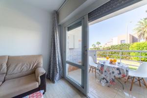 a living room with a couch and a table at Gaviotas 4 in Aguadulce