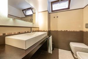 a bathroom with a large tub and a toilet at Casa Michelle in Villaputzu +21 photos