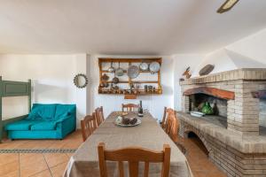 a living room with a table and a fireplace at Casa Michelle in Villaputzu