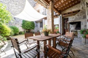 a wooden table and chairs on a patio at El Clos 3 in Conesa
