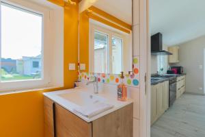 a kitchen with a sink and a window at Le paradis sur mer in Paimpol +24 photos