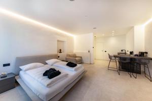 a bedroom with a large white bed and a table at App 203 Palazzo Cavour in Bolzano +3 photos
