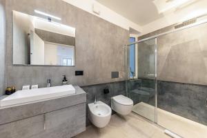 a bathroom with a sink and a toilet and a shower at App 203 Palazzo Cavour in Bolzano