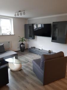 a living room with a couch and a table at Lila Pause in Ellweiler