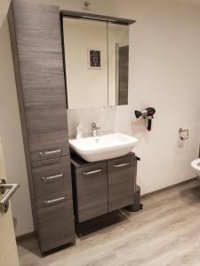 a bathroom with a sink and a mirror at Lila Pause in Ellweiler +13 photos