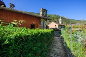a wooden path next to a building with a fence at The Waterfall Chalet in La Salle