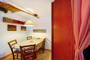 a dining room with a table and chairs and a red door at The Waterfall Chalet in La Salle +19 photos