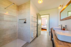 a bathroom with two sinks and a walk in shower at Maison Stoubenn in Kerlouan +17 photos