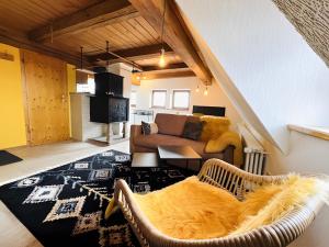 a living room with a couch and a table at Ferienwohnungen Im Eugenhaus in Rosenfeld