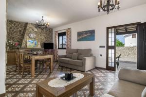 a living room with a couch and a table at Casa Carmelo 2 familias o parejas in Conil de la Frontera