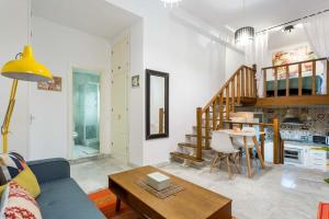 a living room with a couch and a table at Duplex Seville-Historic Center in Seville