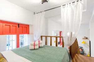 a bedroom with a bed and a window at Duplex Seville-Historic Center in Seville