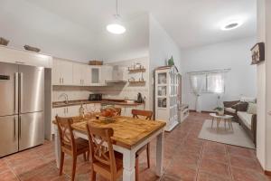 a kitchen with a wooden table and chairs in a kitchen at Casa Eusebia in Arona