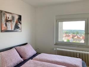 a bedroom with a bed and a window at Dmon-Home in Tettnang