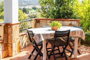 a table and chairs sitting on a balcony at I girasoli in Villasimius
