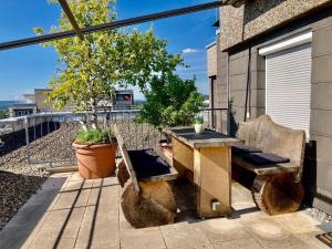 a patio with a table and chairs on a balcony at Dmon-Home in Tettnang