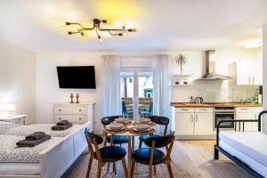 a kitchen and living room with a table and chairs at Aposto Apartments 1 in Oberderdingen +10 photos