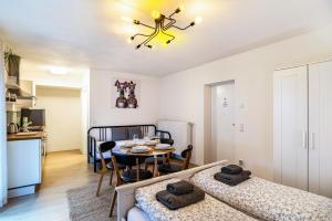 a room with two beds and a dining room with a table at Aposto Apartments 1 in Oberderdingen