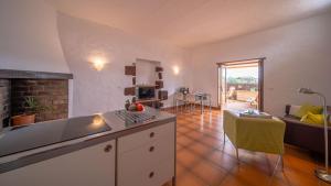 a kitchen and living room with a couch and a table at Casa Margarita 2 in Mala