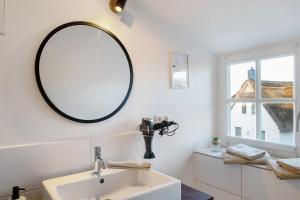 a bathroom with a sink and a mirror on the wall at Ferienhaus Mühlenperle in Güstow +18 photos
